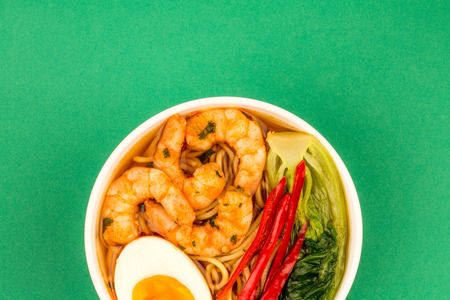 Japanese Style Prawn And Noodle Ramen Soup With Pak Choi And Chillies Against A Green Backgroundの写真素材