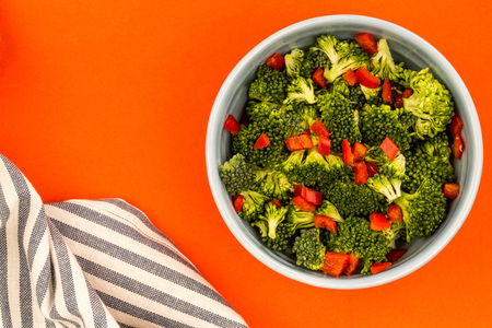 Vegetarian or Vegan Food Bowl Of Broccoli And Chilli Against A Red Backgroundの写真素材