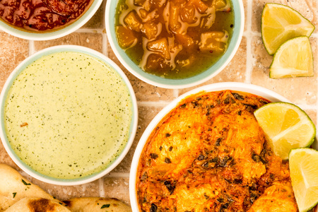  Indian Style Chicken Saag Masala Curry On A Tiled Kitchen Table Top With Naan FLat Bread Mango...