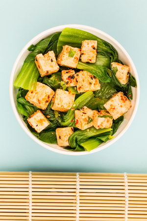 Chinese Style Pak Choi With Tofu Against A Blue Backgroundの写真素材