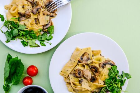 Italian Style Vegetarian Mushroom Pappardelle Pasta Meal With a Fresh Summer Green Saladの写真素材