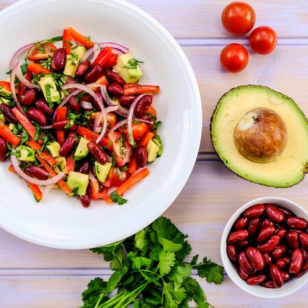 Healthy Vegetarian Avocado and Kidney Bean Summer Salad With Cherry TOmatoes Onions and Red Peppersの写真素材