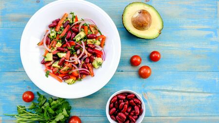 Healthy Vegetarian Avocado and Kidney Bean Summer Salad With Cherry TOmatoes Onions and Red Peppersの写真素材