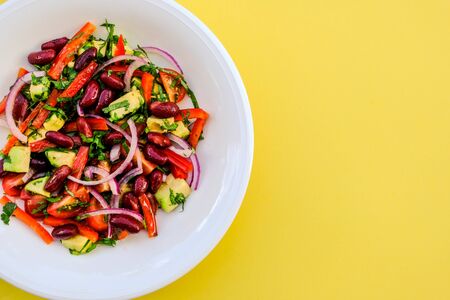 Healthy Vegetarian Avocado and Kidney Bean Summer Salad With Cherry TOmatoes Onions and Red Peppersの写真素材