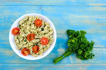 Healthy Lunch Bowl of Italian Style Pasta Salad With Cherry Tomatoes, Pesto and Spinachの写真素材
