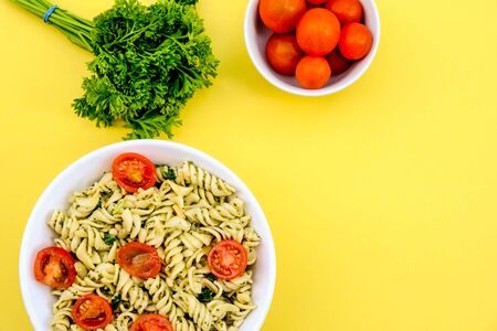 Healthy Lunch Bowl of Italian Style Pasta Salad With Cherry Tomatoes, Pesto and Spinachの写真素材
