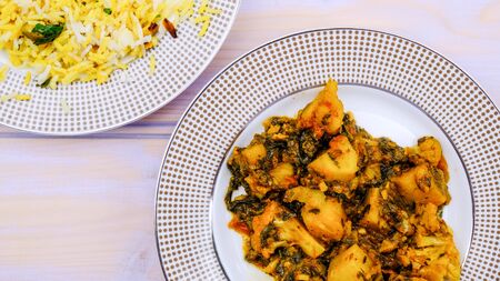 Indian Style Vegetarian Aloo Gobi Saag , Potato, Cauliflower and Spinach in a Spicy Sauce With Rice