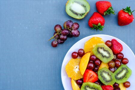 Healthy Vegetarian Fresh Fruit Summer Salad Dessert With Oranges, Strawberries, Kiwi Fruit Peaches and Grapesの写真素材