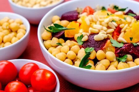 Vegetarian Bulgur Wheat and Quinoa Lunch Bowl With Orange Segments, chickpeas, Beetroot and Tomatoes
