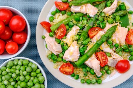 Healthy Summmer Lunch Poached Salmon and Vegetables With Garden Peas, Tomatoes and Fresh Asparagusの写真素材