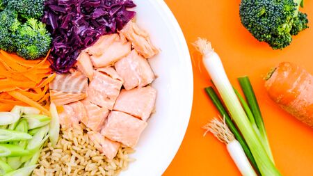 Fresh Healthy Salmon Poke Bowl With Broccoli, Carrots, Wholegrain Rice and Spring Onionsの写真素材