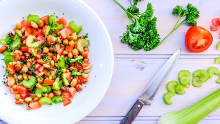 Fresh Healthy Vegetarian Mixed Bean Summer Salad With Celery, Tomatoes and Parsleyの写真素材