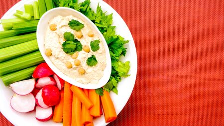 Mediterranean Hummus With Fresh Vegetables Including Carrots, Celery and Radishes Cruditesの写真素材