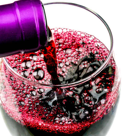 Pouring A Glass Of Red Wine Alcohol Against A White Background With No People