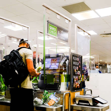 Male Shopper Paying For Shopping At A Self Service Till In John Lewis Waitrose Supermarketのeditorial素材
