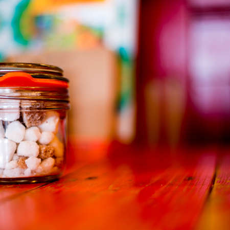 Brown and White Sugar Lumps In A Glass Container Or Jar With No Peopleの写真素材