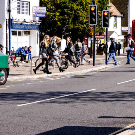 London UK, September 28 2020, Group Of Young People Crossing Road At Traffic Lights COVID-19