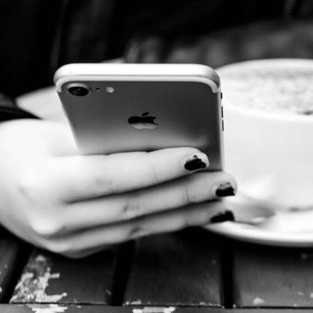 London UK October 06 2020, Close up Of A young Woman Holding And Using Her Smartphone Checking NHS Track And Trace For COVID-19のeditorial素材