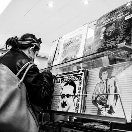 London UK October 06 2020, Young Woman Looking Though Collection Of Vinyl Long Playing Records In A Charity Shopのeditorial素材