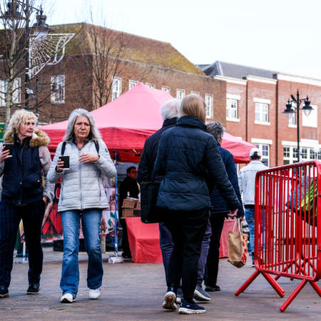London UK, November 12 2020, Two Senior Women Carrying Cups Of Takeaway Coffee Hot Beverage Walking Through An Outdoor Marketのeditorial素材