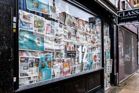 London UK, March 26 2021, Closed Shop Window Covered Up With Newspapers During Covid-19 Coronavirus Lockdownのeditorial素材