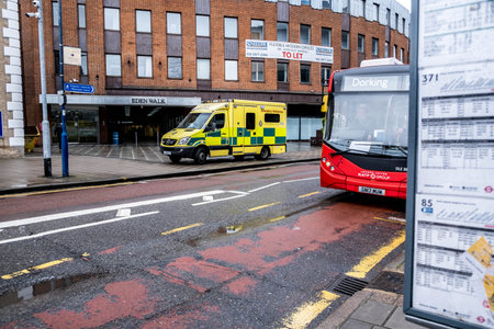 London UK, March 26 2021, London NHS Ambulance And A Red Bus On An Empty High Street During Covid-19 Coronavirus Lockdownのeditorial素材