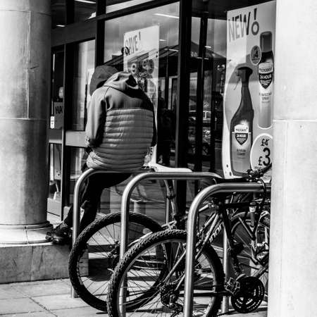 Epsom Surrey, London UK, April 5 2021, Young Man Wearing A Hoody Alone Sitting On A Bicycle Parking Standのeditorial素材