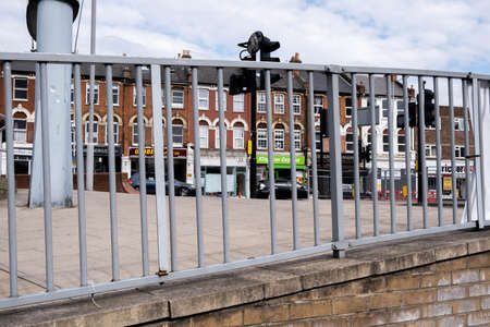 Kingston-Upon Thames London, April 27 2021, Row Of Shops Or Stores On An Empty Town Centre High Street With Passing Carsのeditorial素材