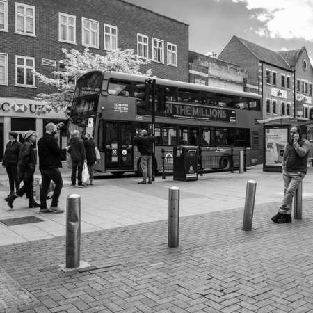 Kingston Upon Thames London, May 07 2021, Shoppers And People Walkiing Past A Bus With A Man Using A Mobile Phoneのeditorial素材