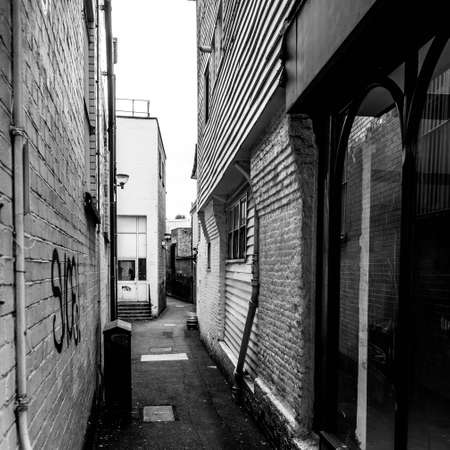 Kingston Upon Thames London, May 07 2021, Old Traditional Narrow Dark Pedestrian Alley Pathway With...