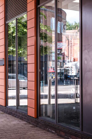 Epsom Surrey, London UK, May28 2022,  Modern Shop Window Reflecting A High Street And Passing...