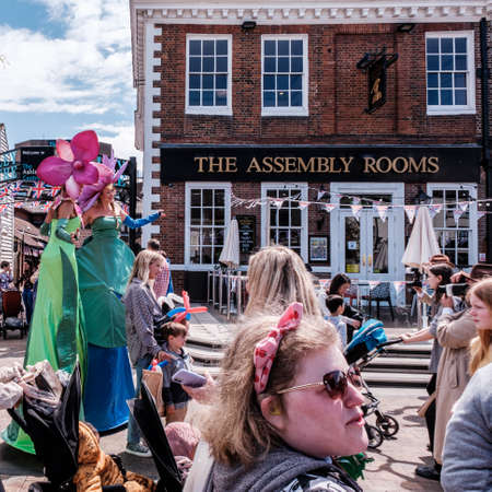 Epsom Surrey, London UK, June 01 2022, Crowds Of Happy People Celebrating Britsh Queen Elizabeths Platinum Jubilee young women Showgirls Dressed As flowers Walking On Stiltsのeditorial素材