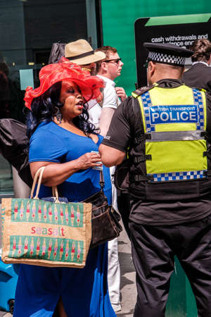 Epson Surrey, London UK, June 03 2022, Black Woman Wearing A Red Hat Outside Epsom Stationのeditorial素材