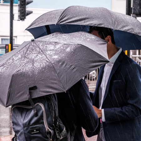 Epsom Surrey, London UK, June 04 2022, Men Sheltering Under Umbrellas On A Wet Rainy Dayのeditorial素材