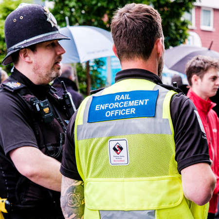 Epsom Surrey, London UK, June 04 2022, Police Officer And Rail Enforcement Officer Standing Talking Outside Railway Stationのeditorial素材