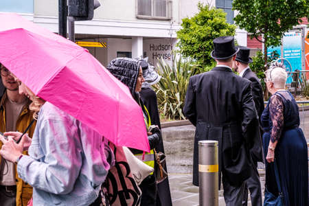 Epsom Surrey, London UK, June 04 2022, Group Of Men And Women Sheltering Under Umbrellas From The Rain On A Wet Dayのeditorial素材