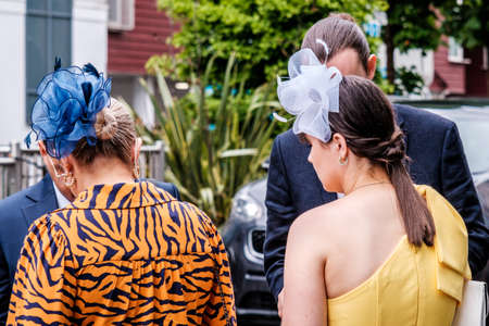 Epsom Surrey, London UK, June 04 2022, Woman Wearing Bright Tiger Print Dress And Blue Headwear Fascinatorのeditorial素材