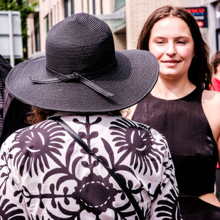 Epsom Surrey, London UK, June 04 2022, Woman With Back To Camera Wearing Wide Rim Black Hat And Patterned Jacketのeditorial素材