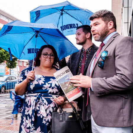 Epsom Surrey, London UK, June 04 2022,  Group Of Men And Women Sheltering Under Umbrellas From The Rain On A Wet Dayのeditorial素材