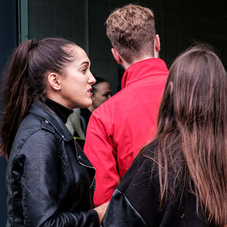 Epsom Surrey, London UK, June 04 2022, Two Girlfriends Talking Wearing Black Coats And Long Hairのeditorial素材
