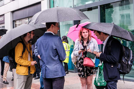 Epsom Surrey, London UK, June 04 2022, Group Of Men And Women Sheltering Under Umbrellas From The Rain On A Wet Dayのeditorial素材