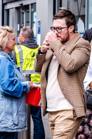 Epsom Surrey, London UK, June 04 2022, Man Wearing Casual Smart Checked Sports Jacket Lighting A Cigaretteのeditorial素材
