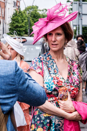 Epsom Surrey, London UK, June 04 2022, Attractive Older Woman Wearing Floral Print Summer Dress And Pink Headwearのeditorial素材