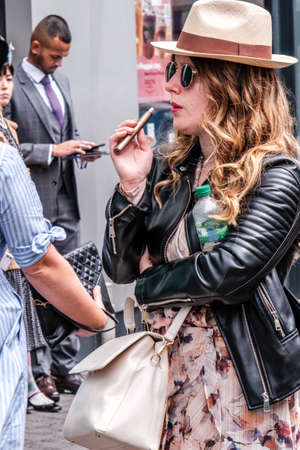 Epsom Surrey, London UK, June 04 2022, Trendy Cool Woman Usine Vape Wearing Panama Hat And Leather Jacketのeditorial素材