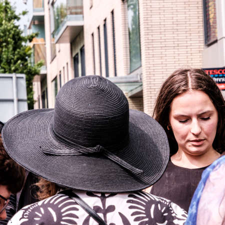 Epsom Surrey, London UK, June 04 2022, Woman With Back To Camera Wearing Wide Rim Black Hat And Patterned Jacketのeditorial素材
