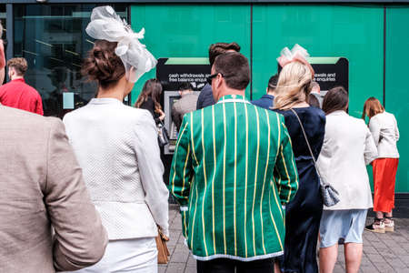 Epsom Surrey, London UK, June 04 2022, Line Of Men And Women Queuing To Withdraw Money From An ATM Cash Point Machineのeditorial素材