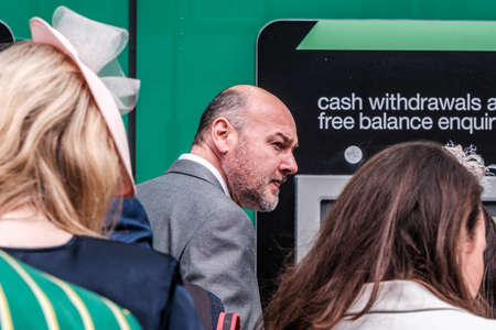 Epsom Surrey, London UK, June 04 2022, Line Of Men And Women Queuing To Withdraw Money From An ATM Cash Point Machineのeditorial素材