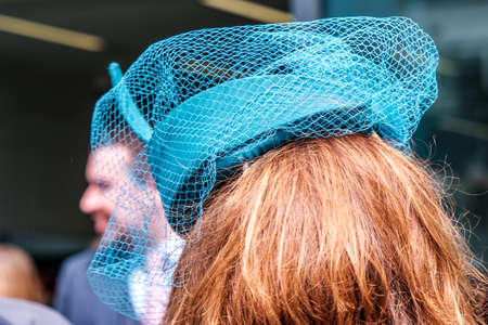 Epsom Surrey, London UK, June 04 2022, Close Up Woman Wearing Turquoise Fascinator Hat With Nettingのeditorial素材