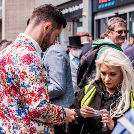 Epsom Surrey, London UK, June 04 2022, Trendy Fashionable Young Man Buying Ticket On Crowded Street