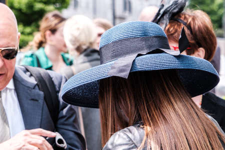 Epsom Surrey, London UK, June 04 2022, Young Woman Wearing Blue Rim Hat With Long Brown Hair Rear Shotのeditorial素材